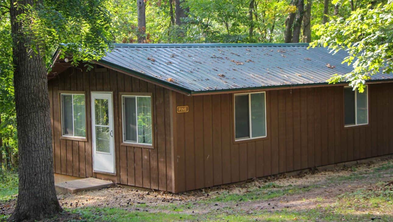 A small summer camp cabin in the woods of Iowa.