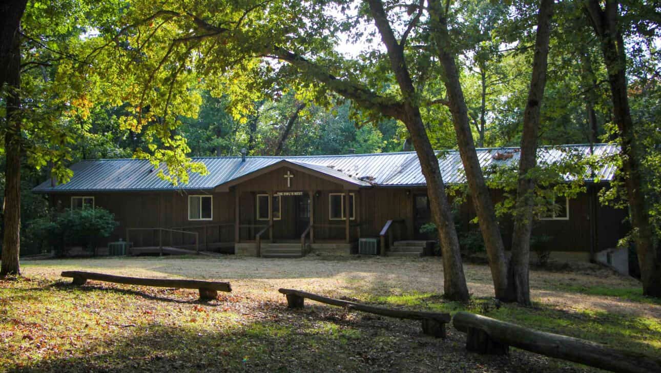 A small summer camp cabin in the woods of Iowa.